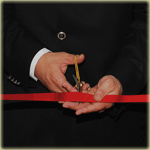 Image of a businessman cutting a ribbon